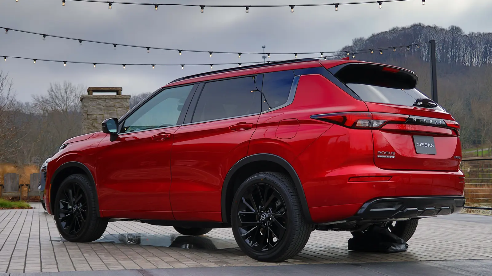 A red 2026 Nissan Rogue rear 3 quarter view