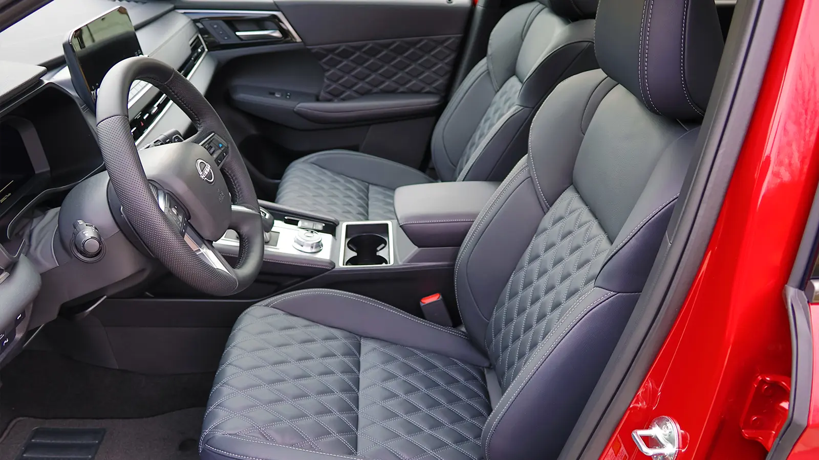 A red 2026 Nissan Rogue drivers side view