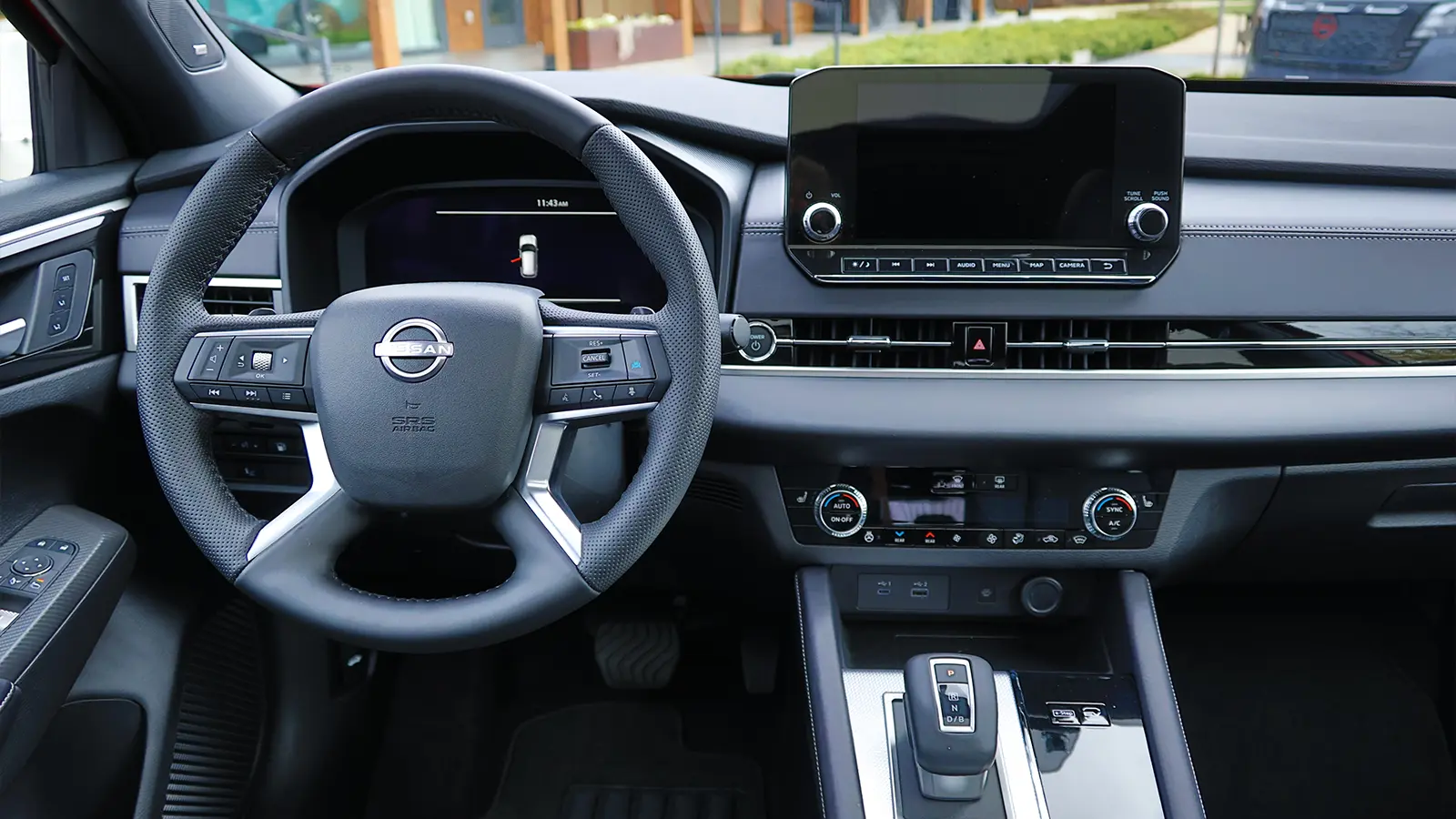 A red 2026 Nissan Rogue driver front view