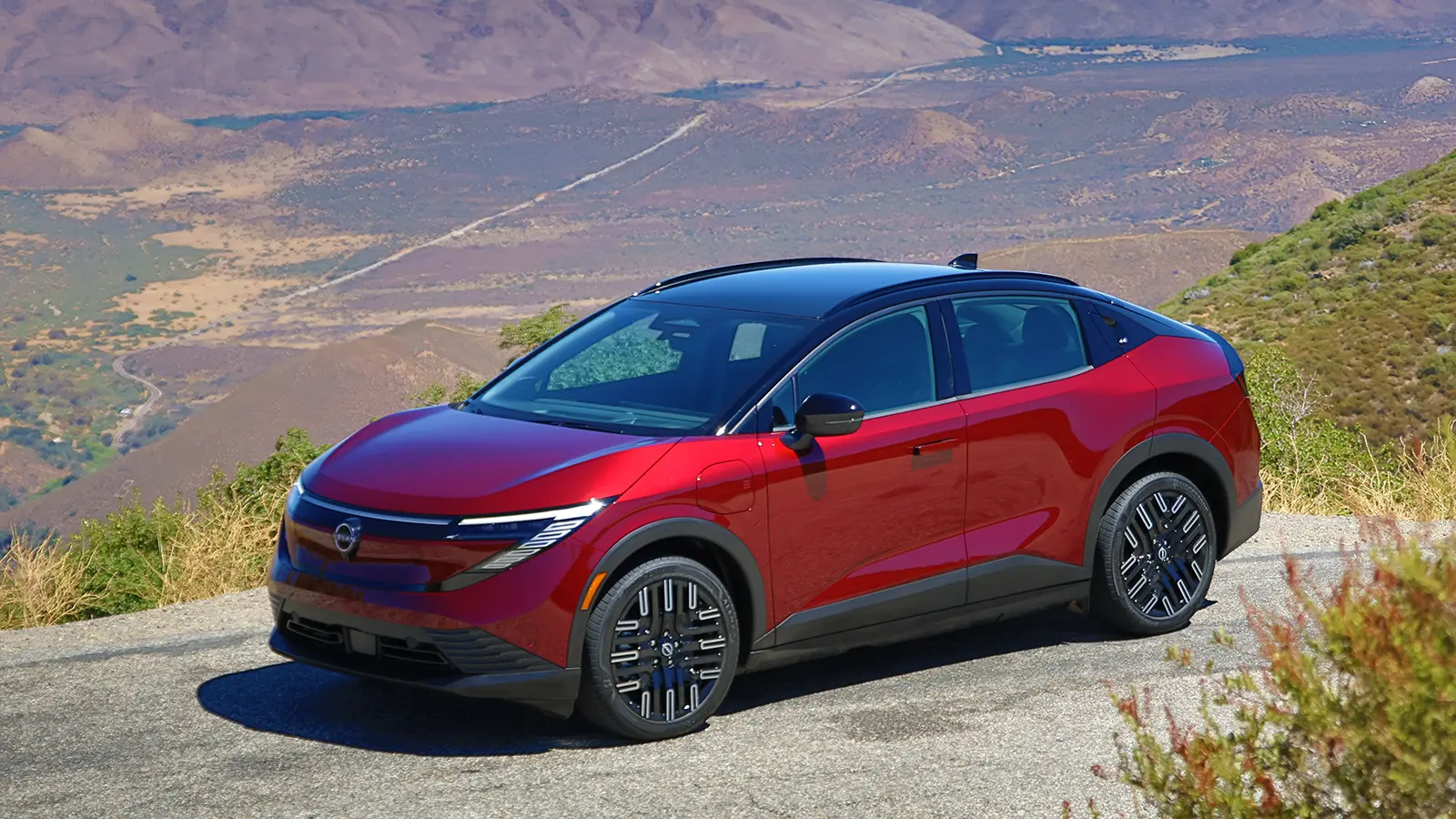 A red 2026 Nissan Leaf parked on a mountain overlook