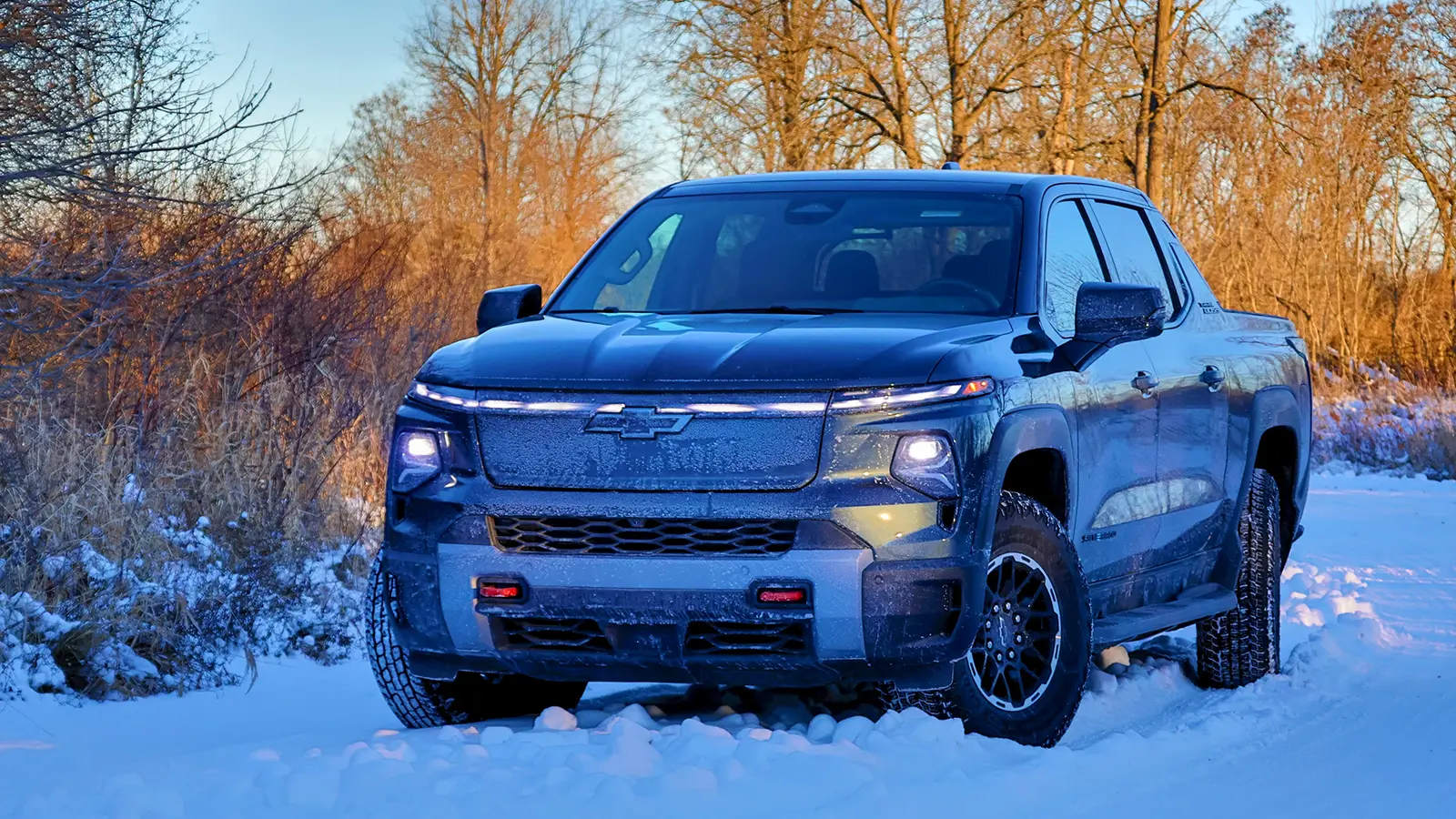 A black Chevrolet Silverado playing in the snow