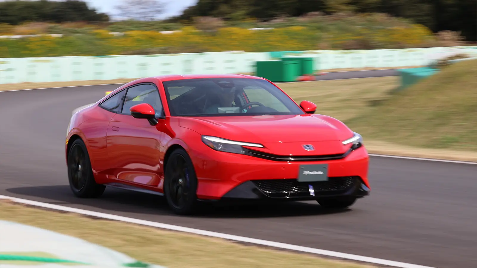 A red 2025 Honda Civic on the track
