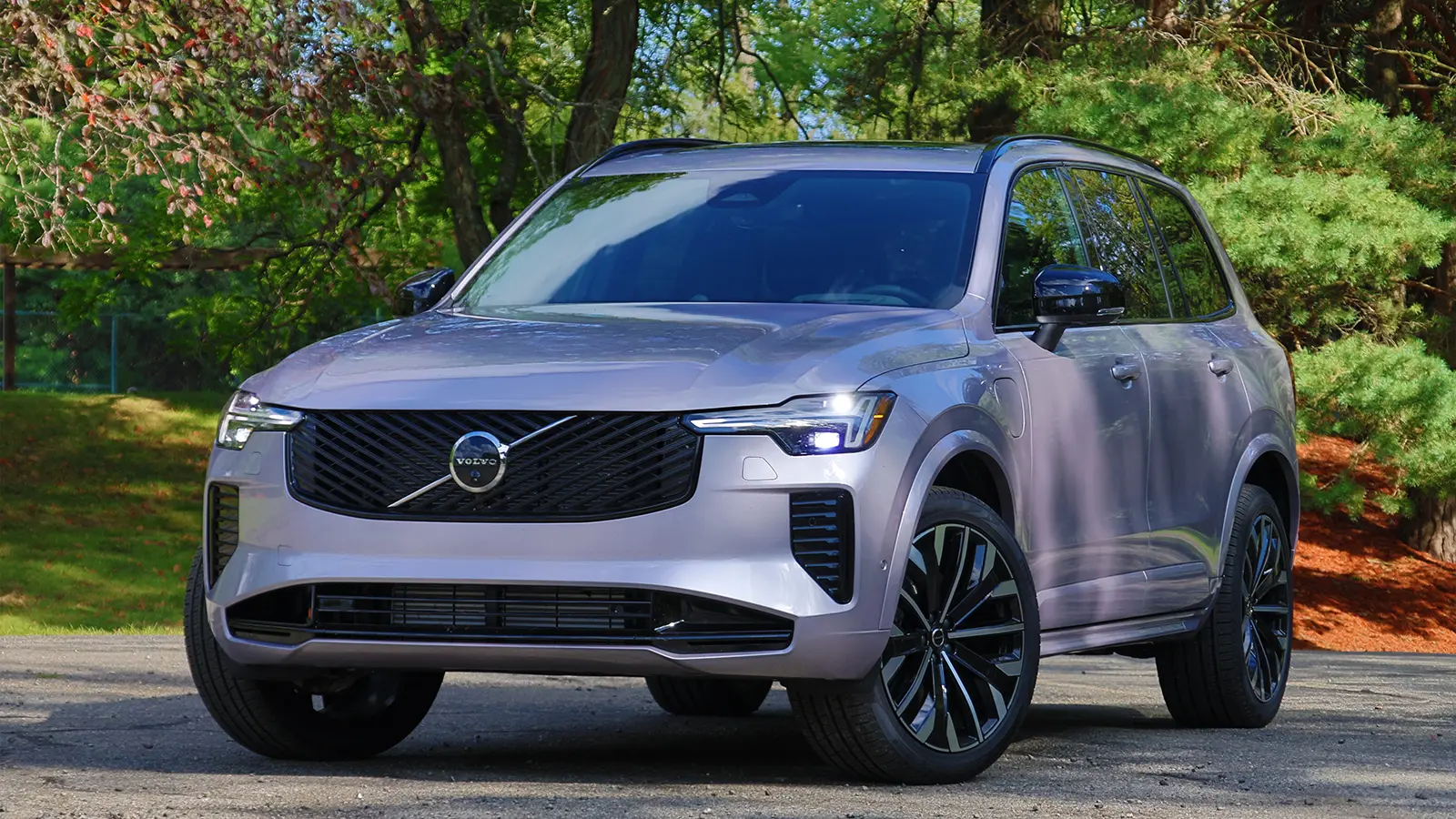 A silver 2025 Volvo XC90 T8 in the forest