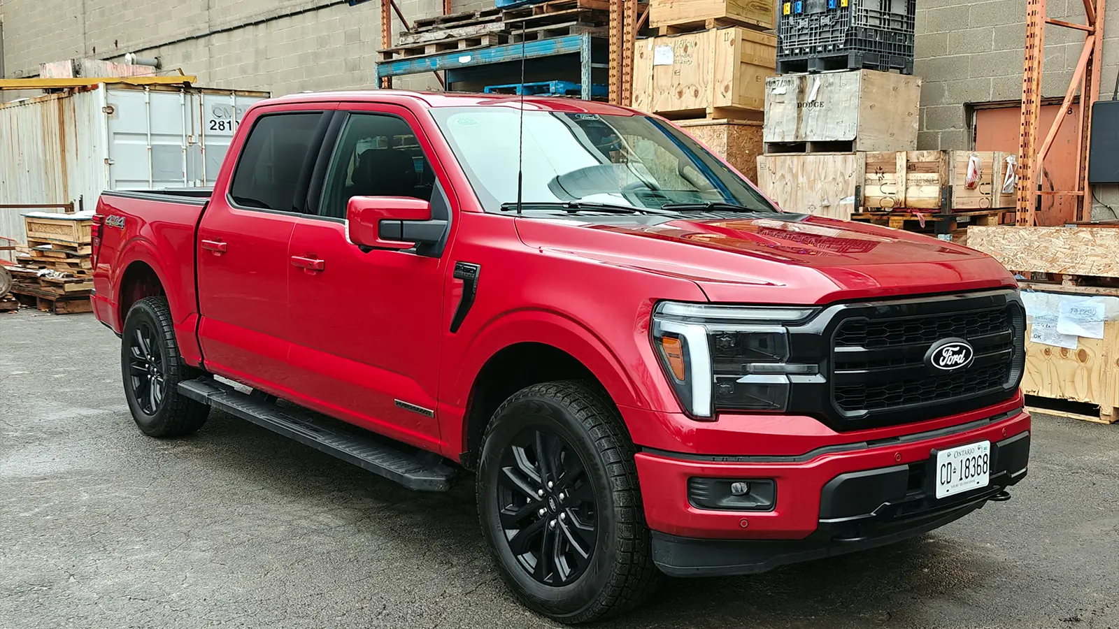 A red 2025 Ford F-150 Powerboost Lariat