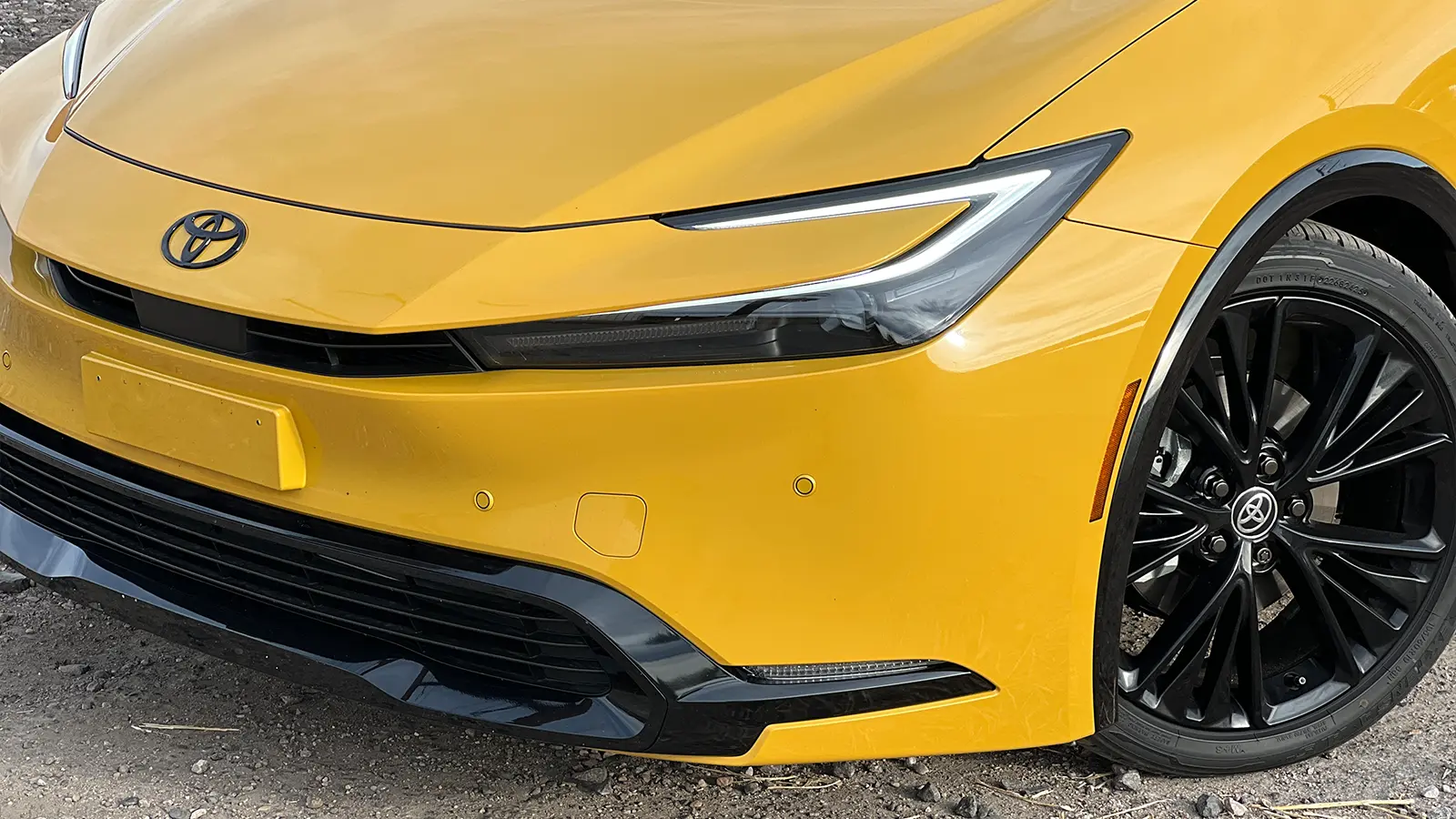 A yellow 2026 Toyota Prius XSE PHEV Nightshade close up