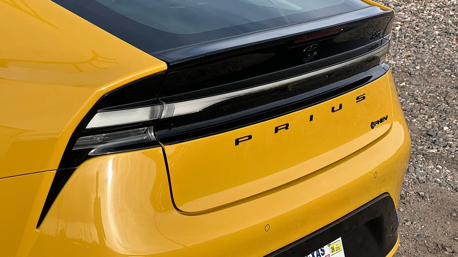 A yellow 2026 Toyota Prius XSE PHEV Nightshade close up of the rear