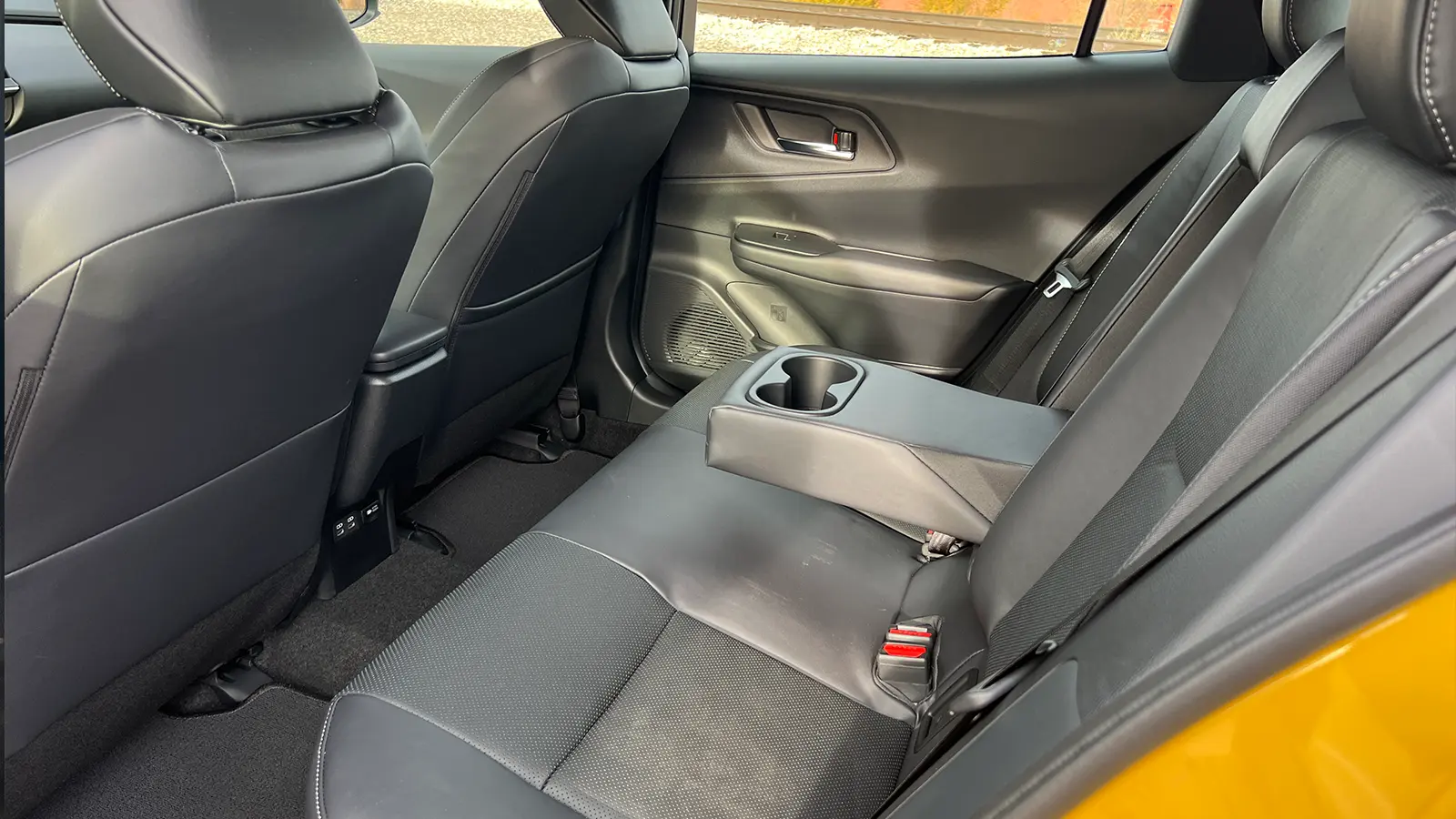 A yellow 2026 Toyota Prius XSE PHEV Nightshade rear seat