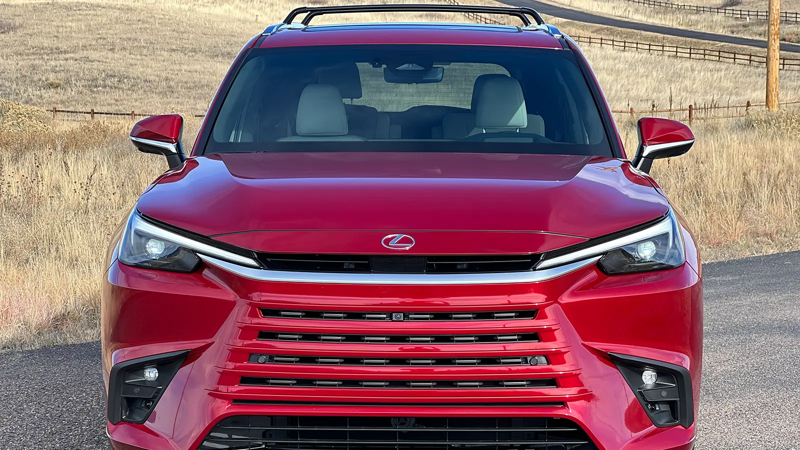 A red 2026 Lexus TX 550h+ PHEV front nose view