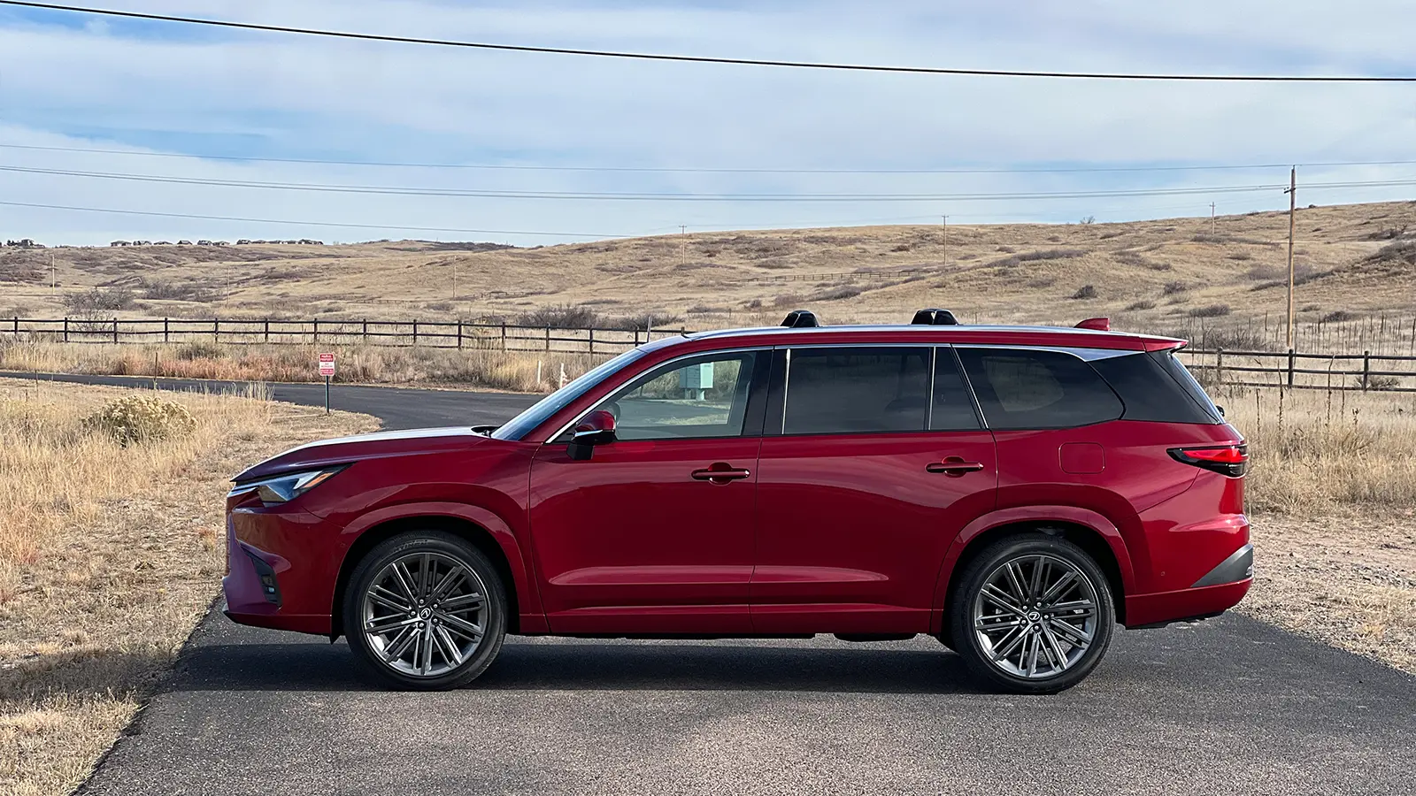 A red 2026 Lexus TX 550h+ PHEV side view