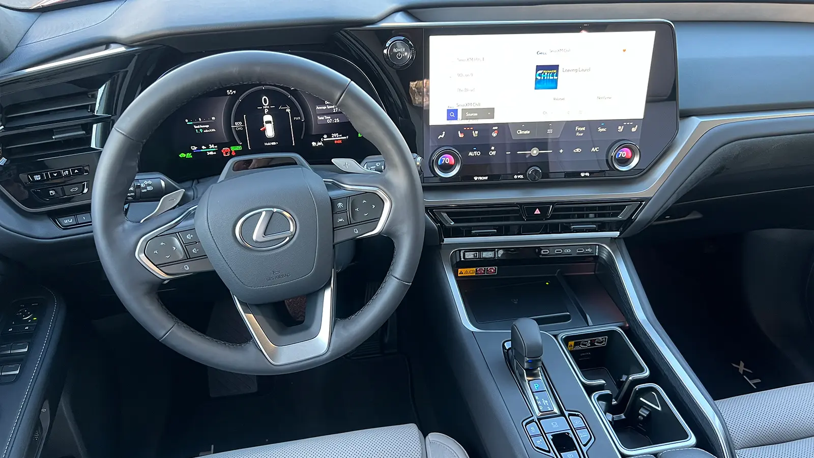 A red 2026 Lexus TX 550h+ PHEV driver HUD view