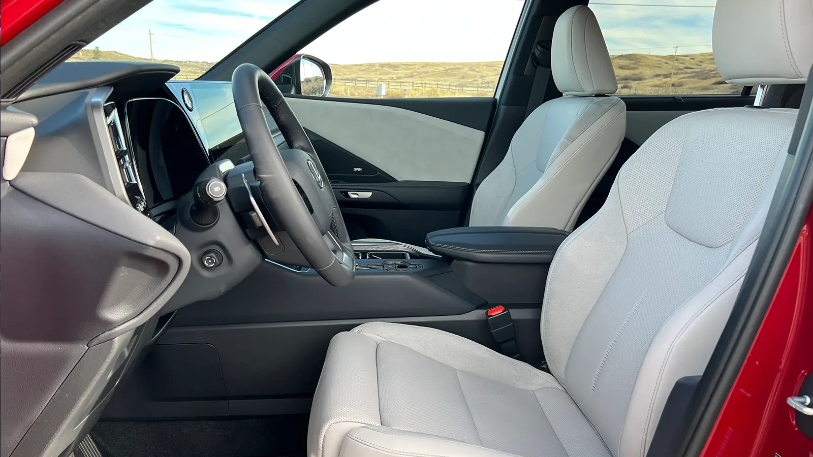 A red 2026 Lexus TX 550h+ PHEV side driver view