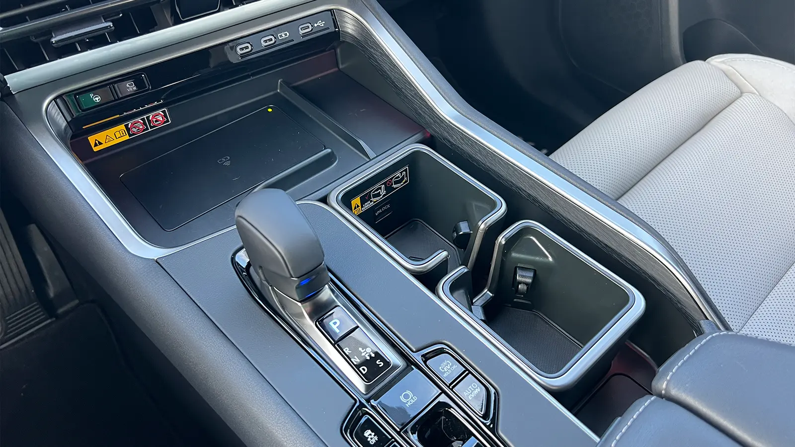 A red 2026 Lexus TX 550h+ PHEV center console view