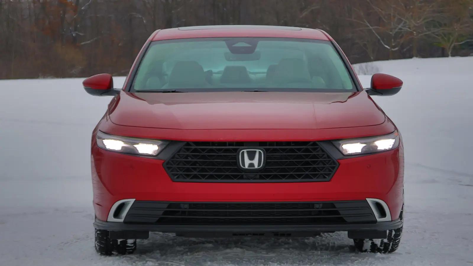 A red 2026 Honda Accord Sport front nose view in the snow