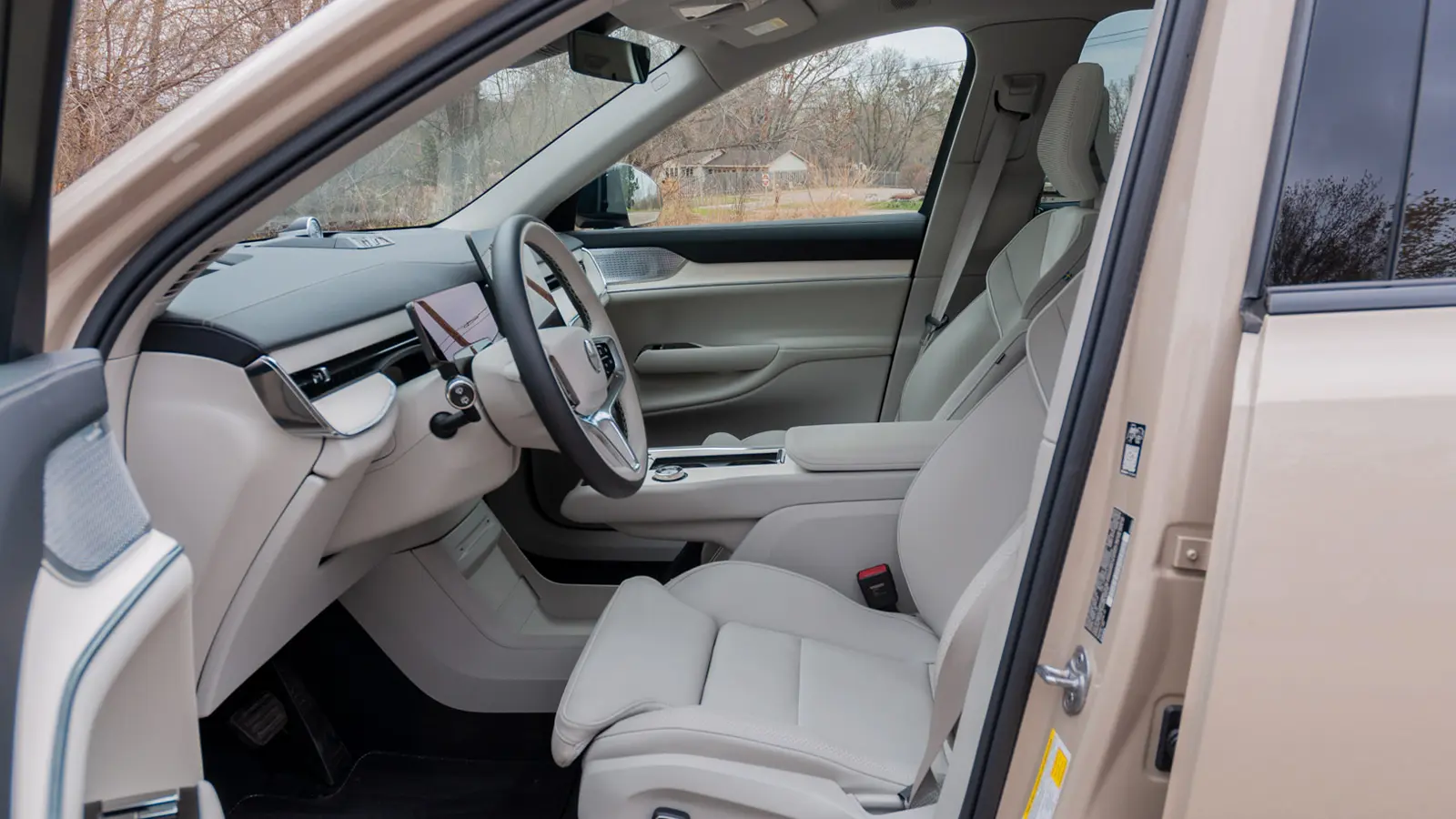 A silver 2025 Volvo EX90 driver side view