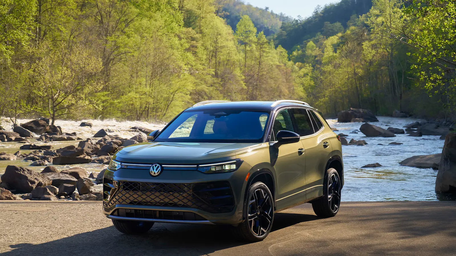 A green gray 2026 Volkswagen Tiguan in the Forest