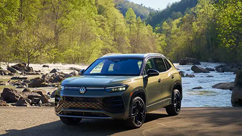 A green gray 2026 Volkswagen Tiguan in the Forest