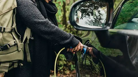 A women charging an EV