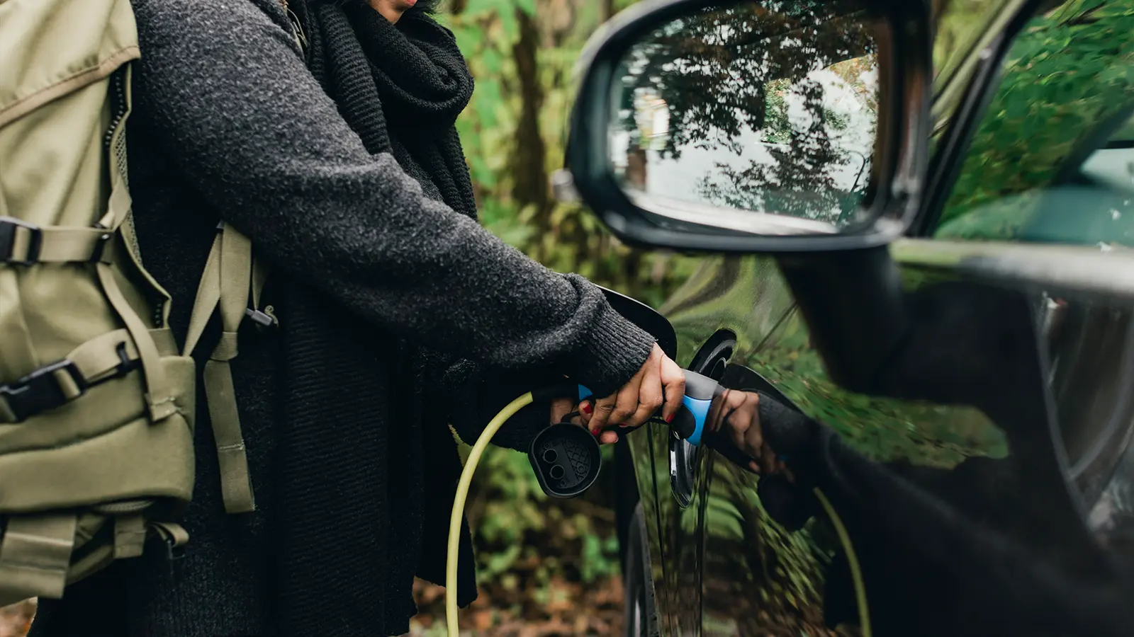 A women charging an EV