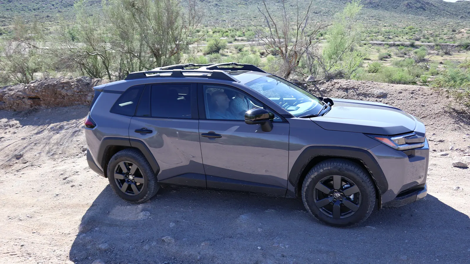 A dark gray 2025 Toyota RAV4 hybrid side view