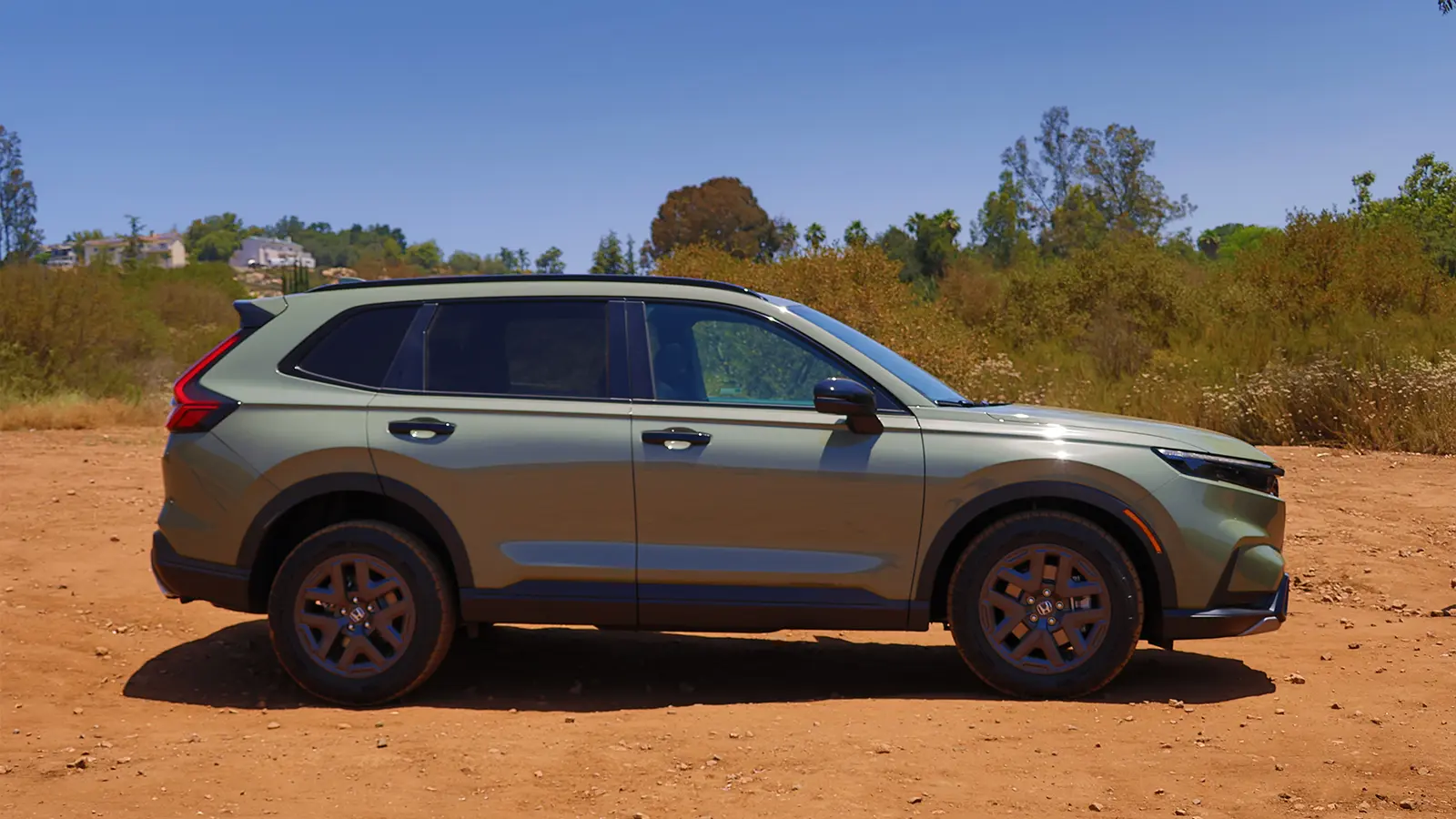 A dark green 2025 Honda CR-V hybrid side view