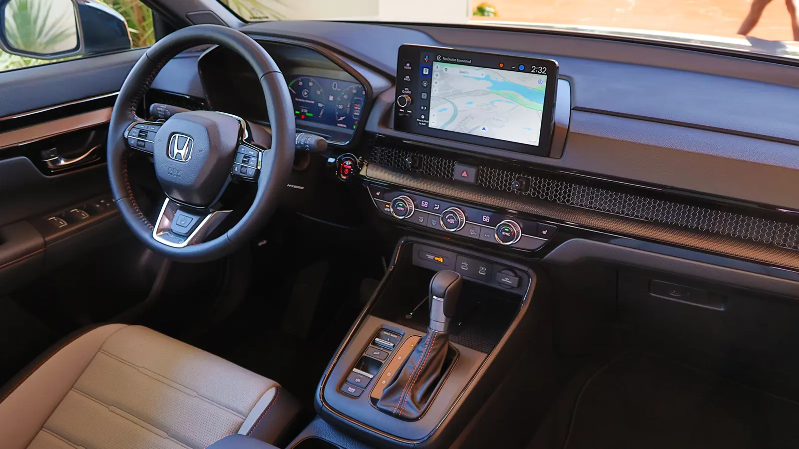 A dark green 2025 Honda CR-V hybrid interior driver view