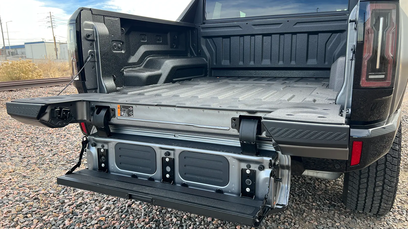 A dark gray 2026 GMC hummer EV pick up rear bed