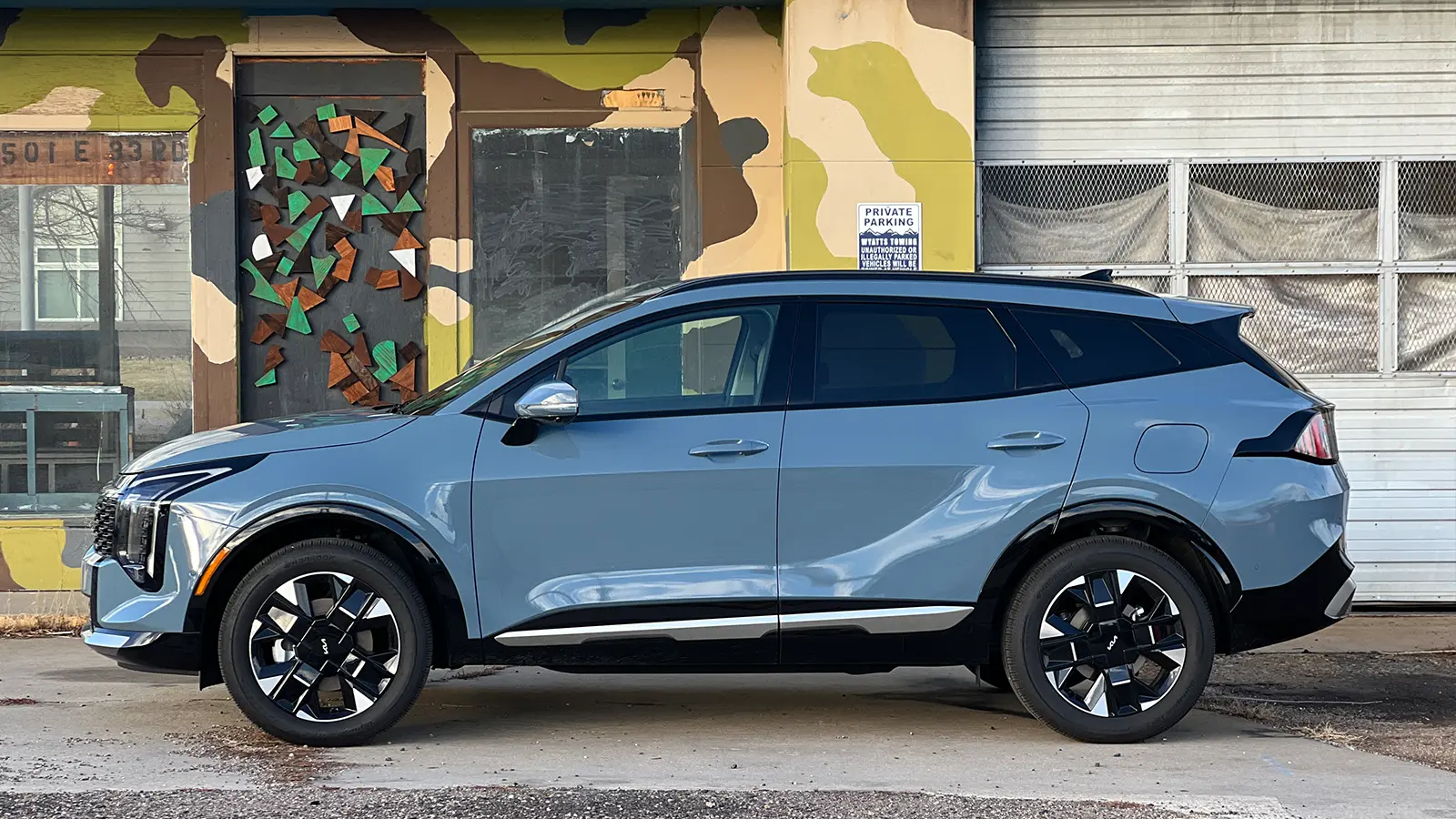 A dark blue 2026 Kia Sportage Hybrid SX Prestige side view
