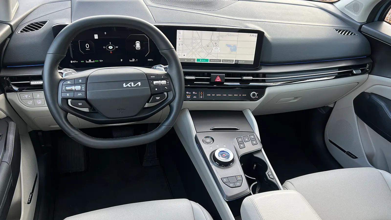 A dark blue 2026 Kia Sportage Hybrid SX Prestige driver front view interior