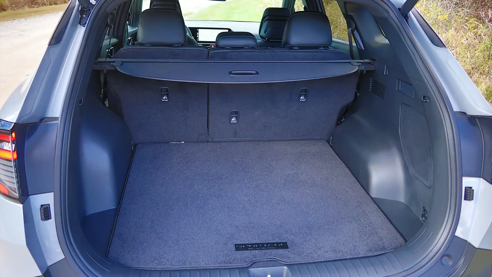 A dark blue 2026 Kia Sportage Hybrid SX Prestige trunk