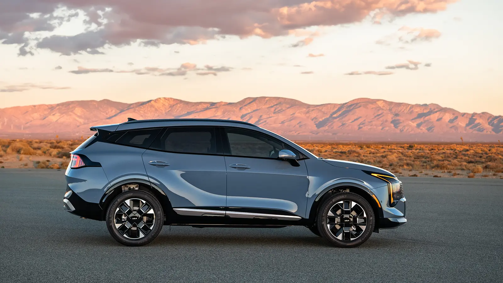 A gray 2026 Kia Sportage side view in the desert