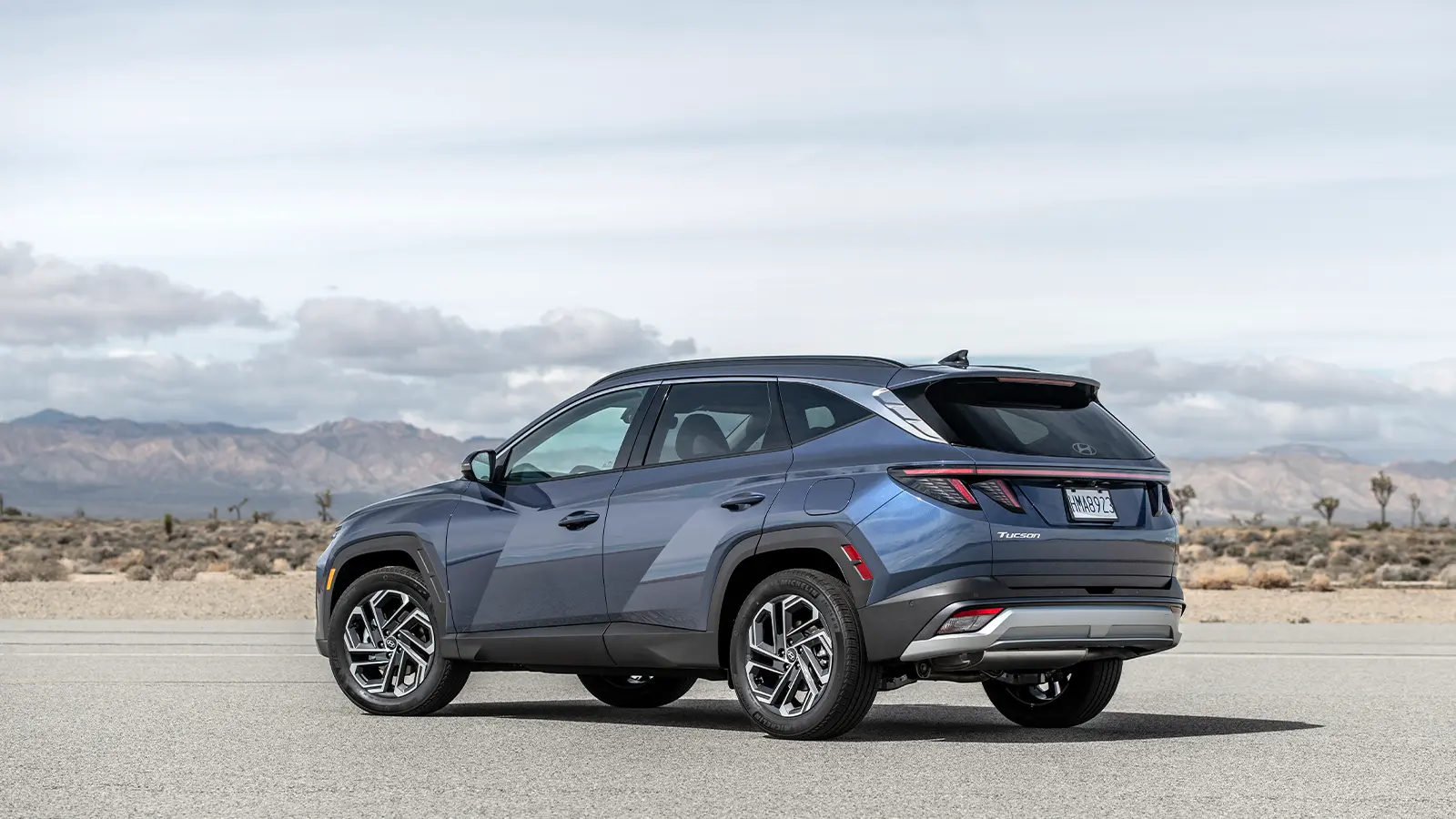 A light blue 2026 Hyundai Tucson Hybrid side view