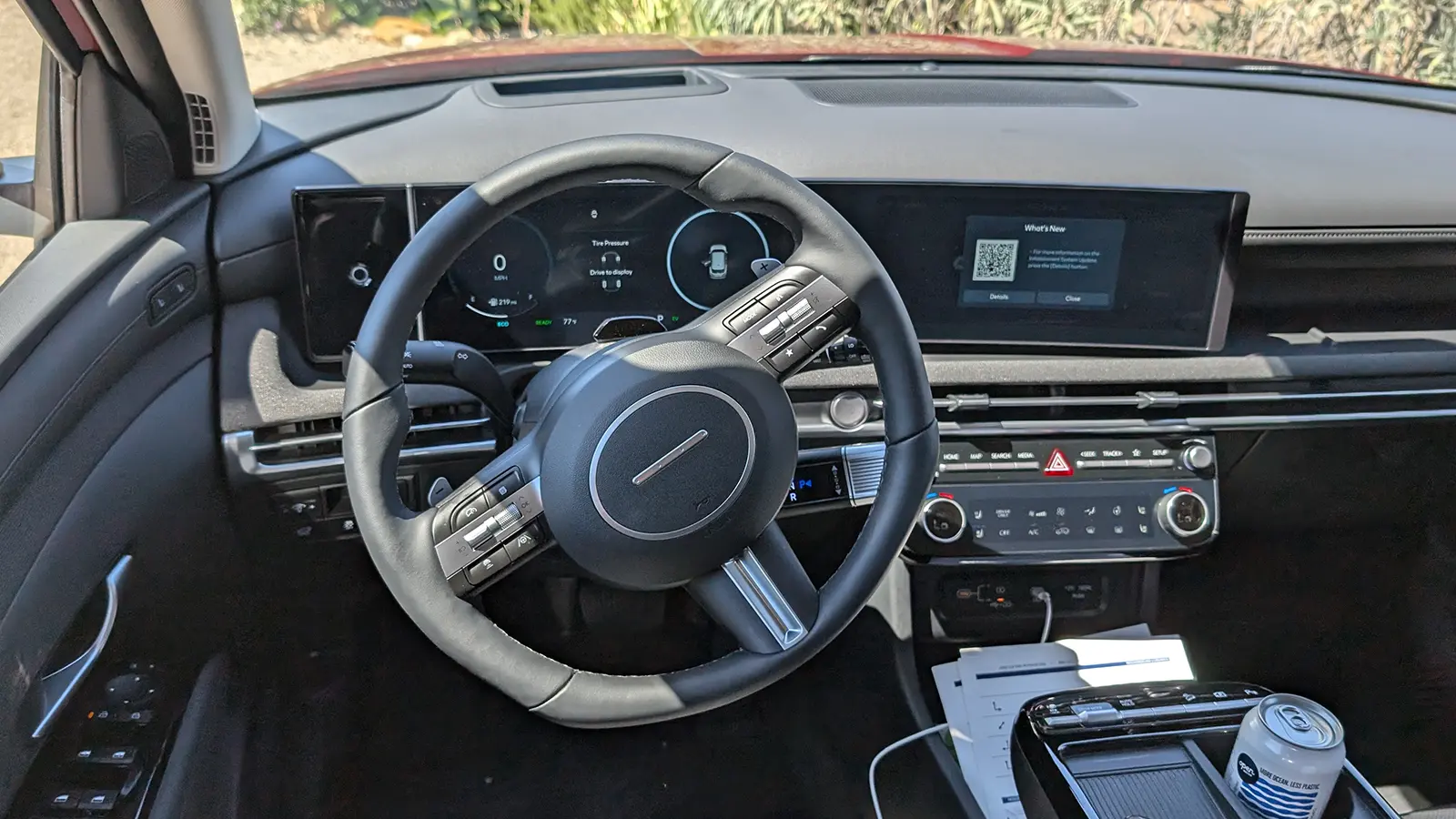 A light blue 2026 Hyundai Tucson Hybrid interior front driver view