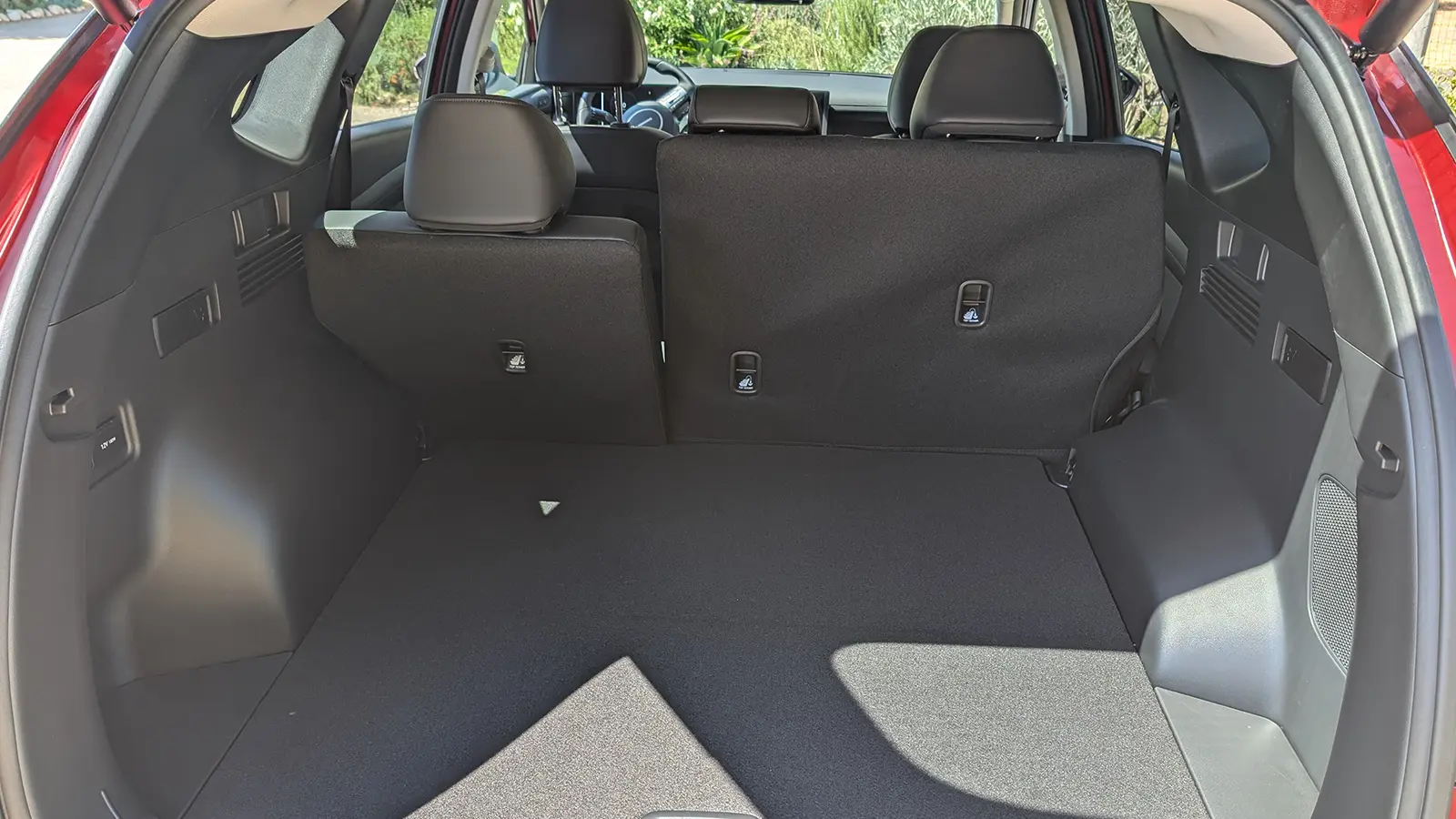 A light blue 2026 Hyundai Tucson Hybrid interior cargo trunk view