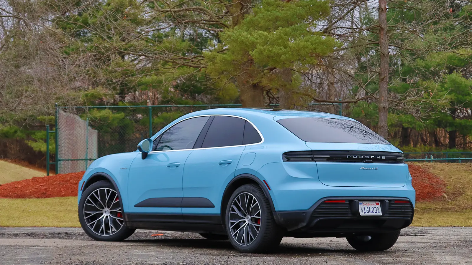 A light blue 2025 Porsche Macan 4S front side three quarter view