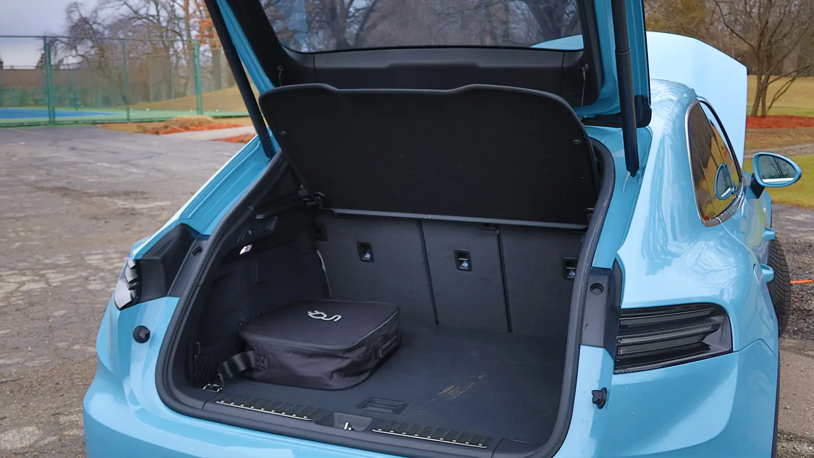 A light blue 2025 Porsche Macan 4S trunk view