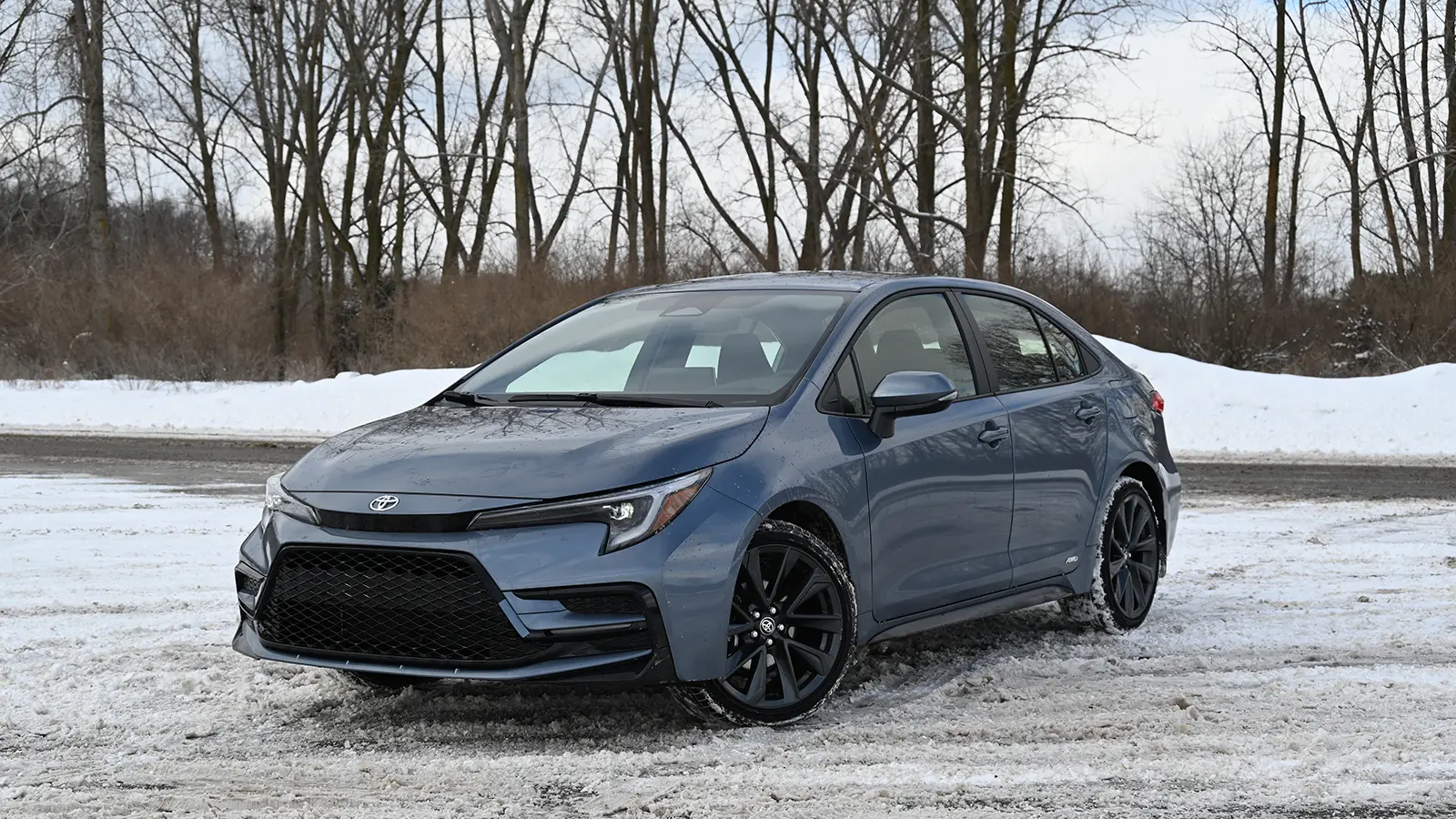 a dark blue 2026 toyota corolla hybrid three quarter view