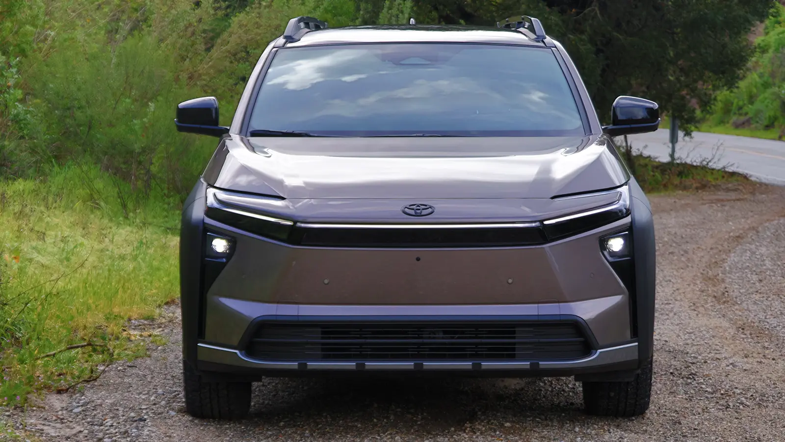 A 2026 Toyota bZ Woodland in the forest front nose view