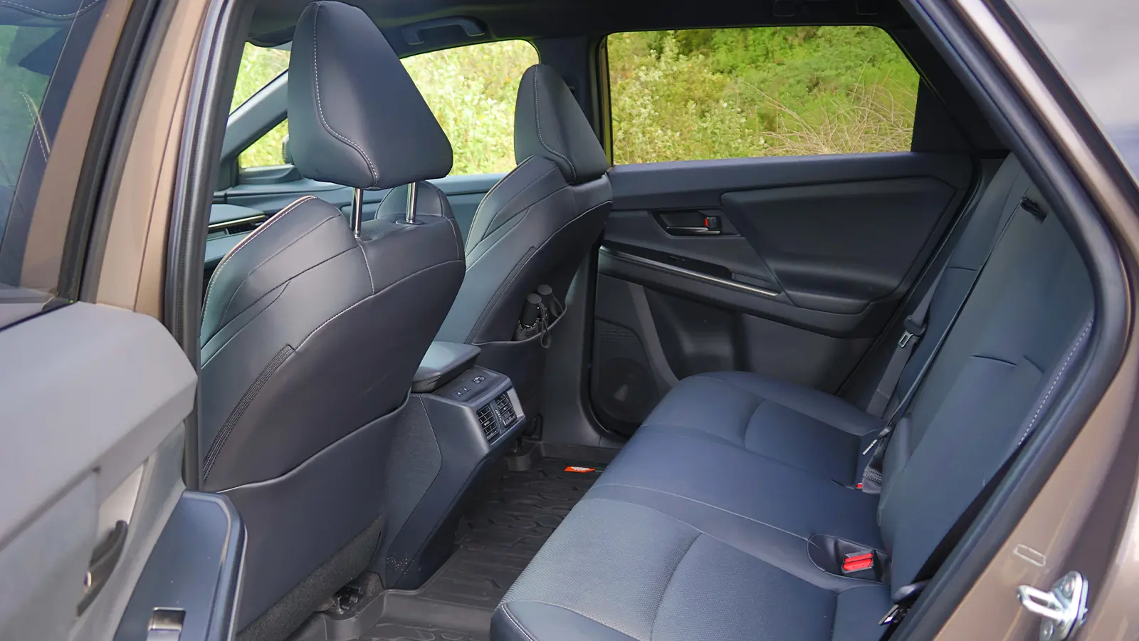 A 2026 Toyota bZ Woodland in the forest rear seat view