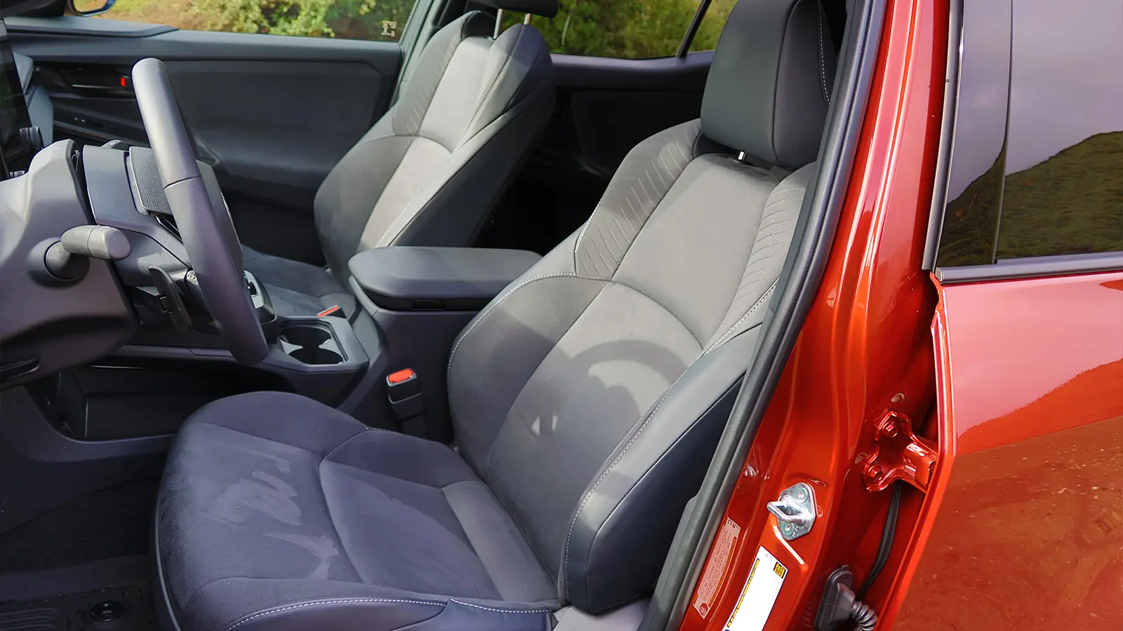 A red 2026 Toyota C-HR driver front seat side view