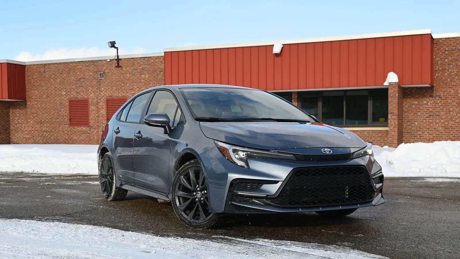 A dark blue 2026 Toyota Corolla hybrid SE front driver rear seat view