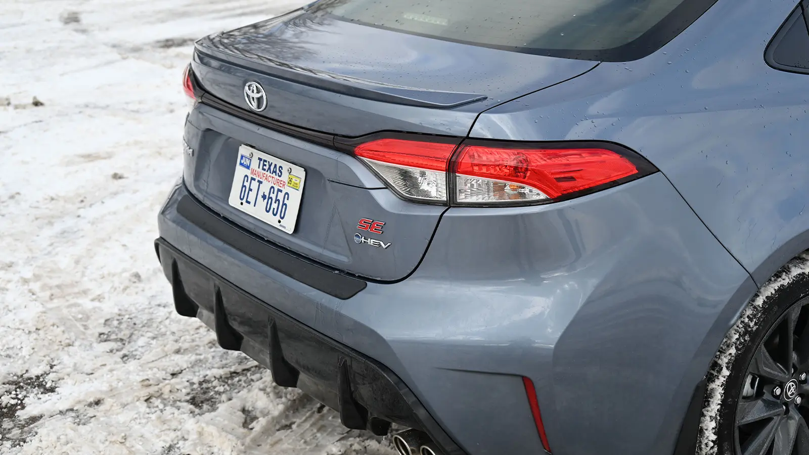 A dark blue 2026 Toyota Corolla hybrid SE rear trunk view