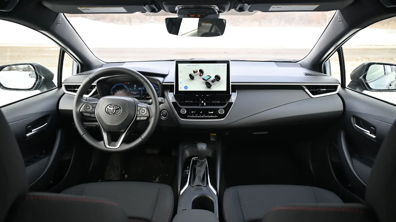 A dark blue 2026 Toyota Corolla hybrid SE front driver HUD view