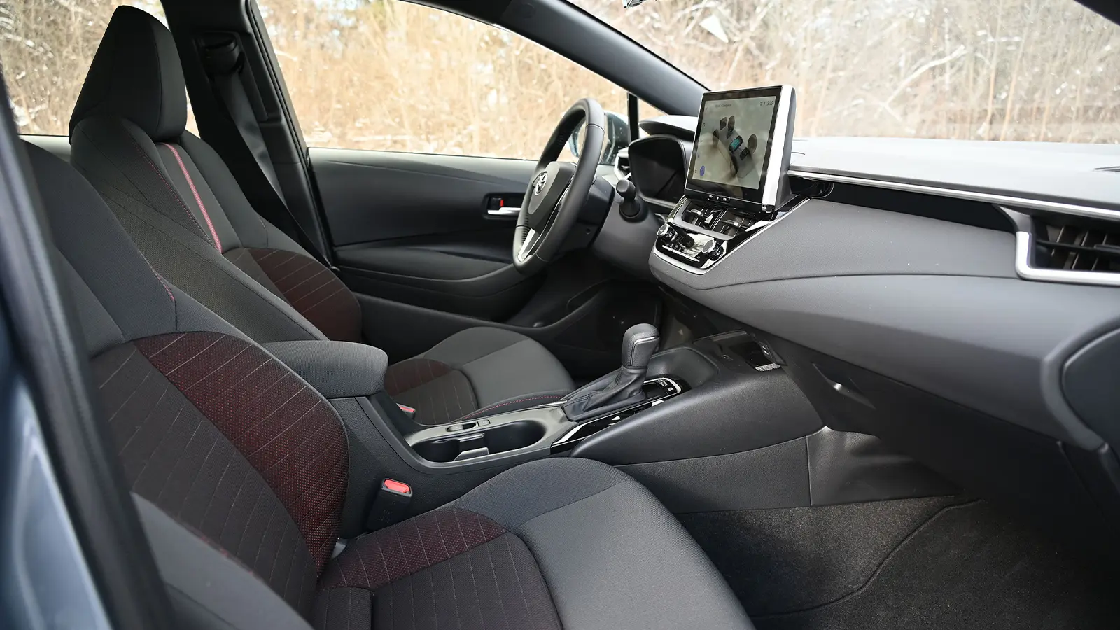 A dark blue 2026 Toyota Corolla hybrid SE front driver rear seat side view