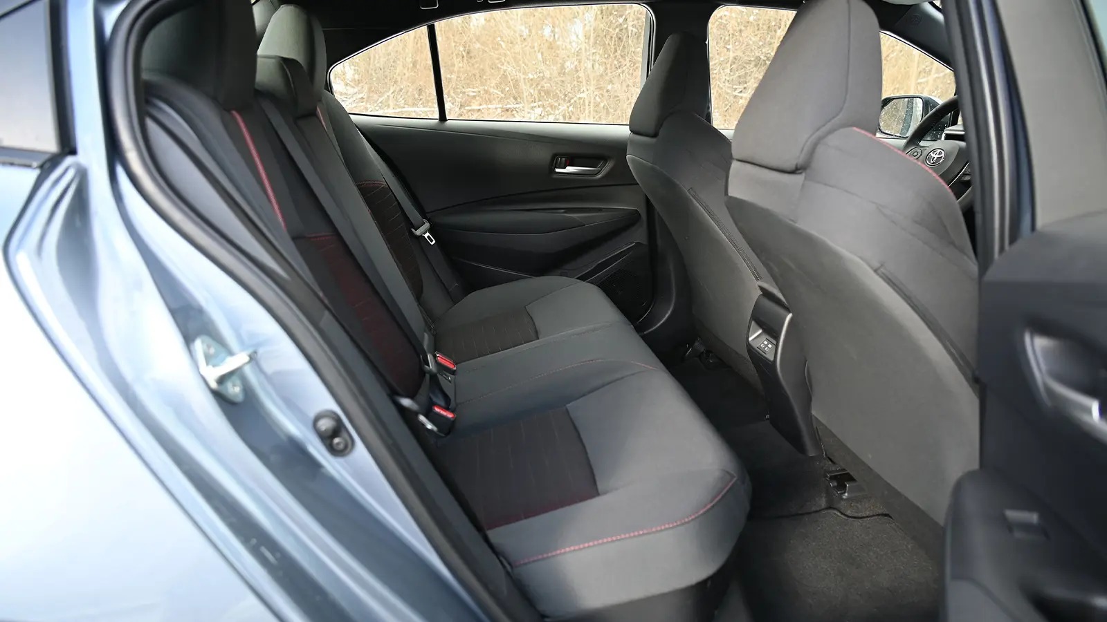 A dark blue 2026 Toyota Corolla hybrid SE rear driver view