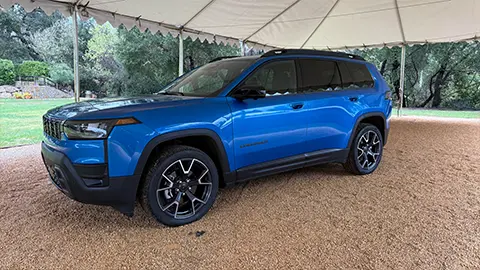 A blue 2026 Jeep Cherokee side three quarter view
