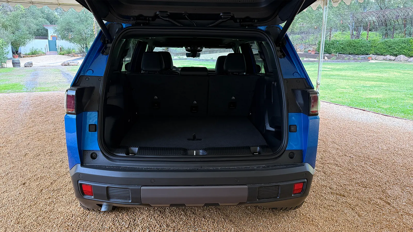 A blue 2026 Jeep Cherokee rear trunk open view