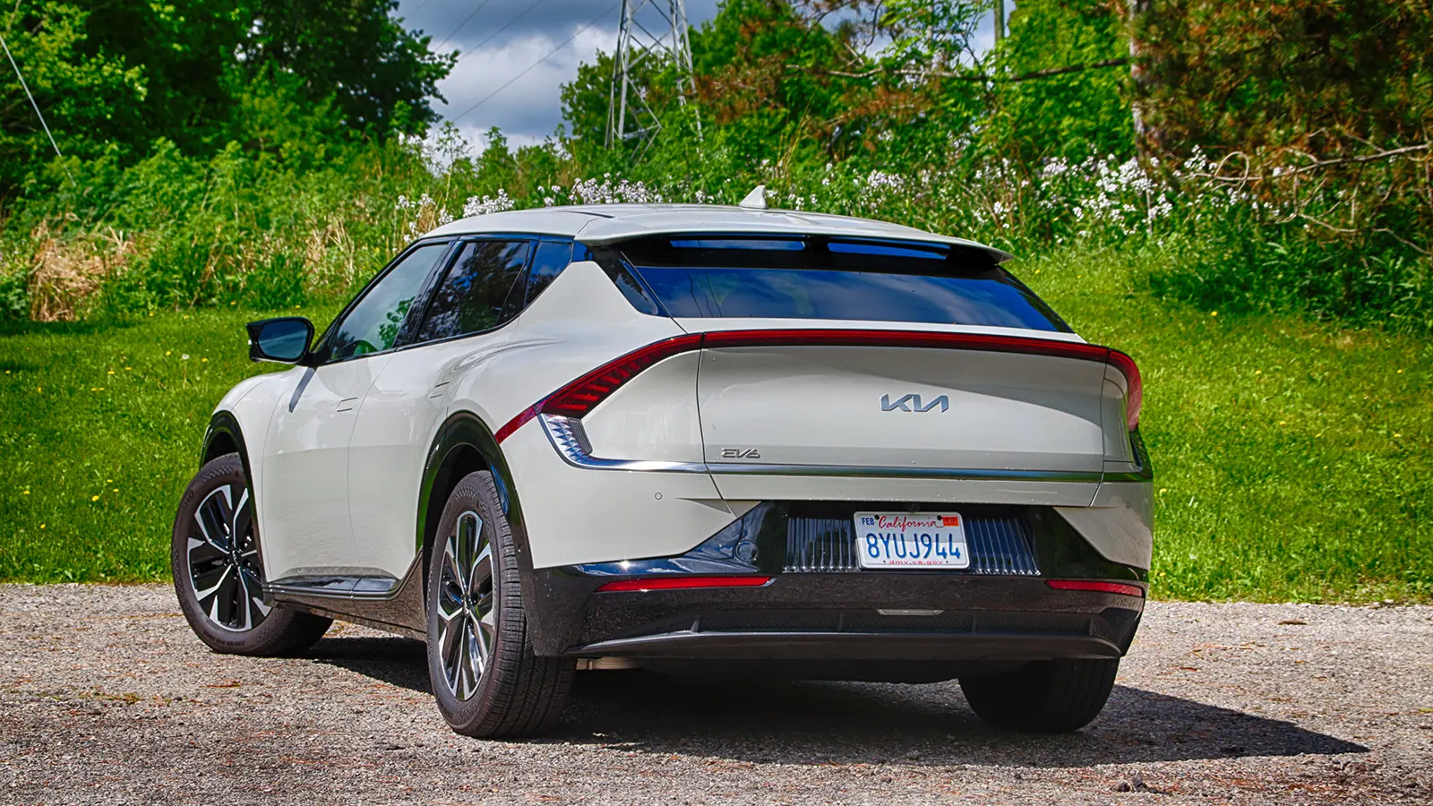 A white 2022 Kia EV6 Wind AWD three quarter rear view