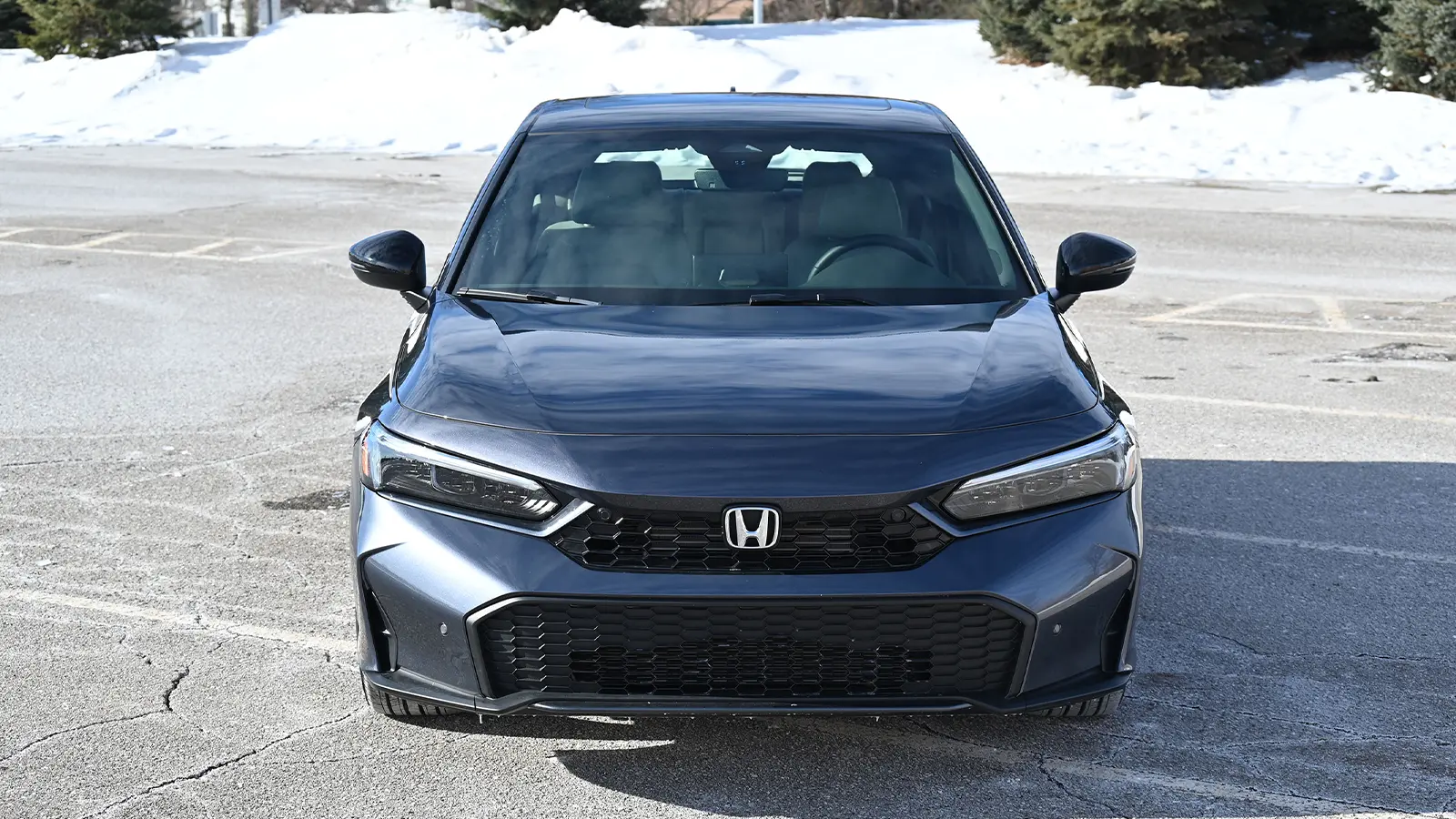 A dark blue 2026 Honda Civic Sport Touring Hybrid nose