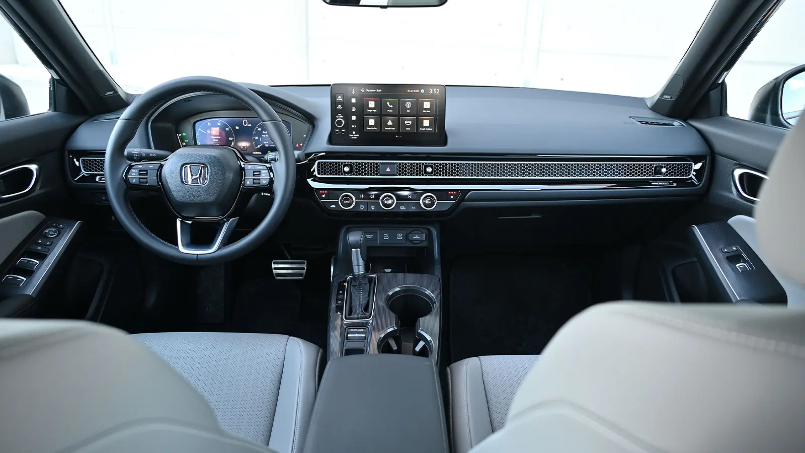 A dark blue 2026 Honda Civic Sport Touring Hybrid interior driver front view