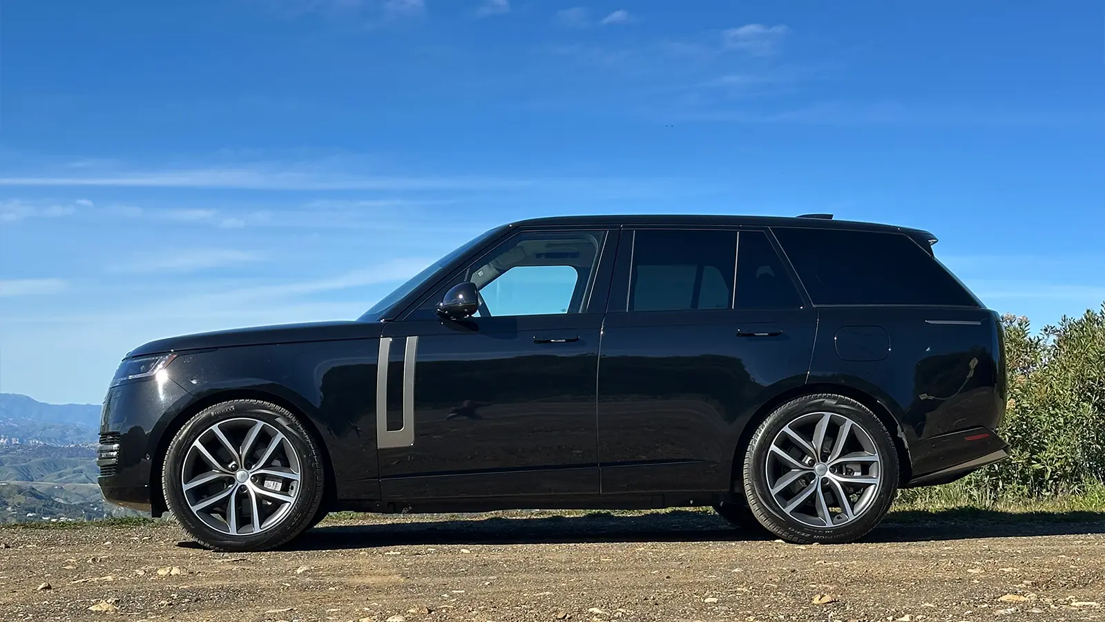 A black 2025 Land Rover Range Rover SE PHEV Review side view